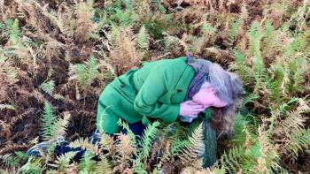Sandrine lying in a field of ferns